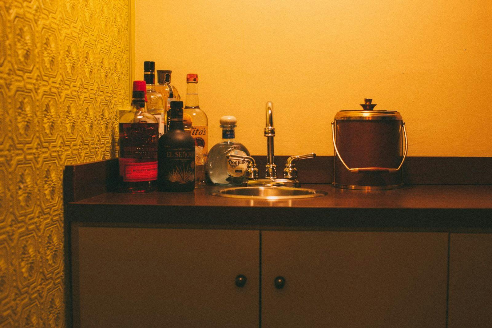 Bar counter with liquor and a sink