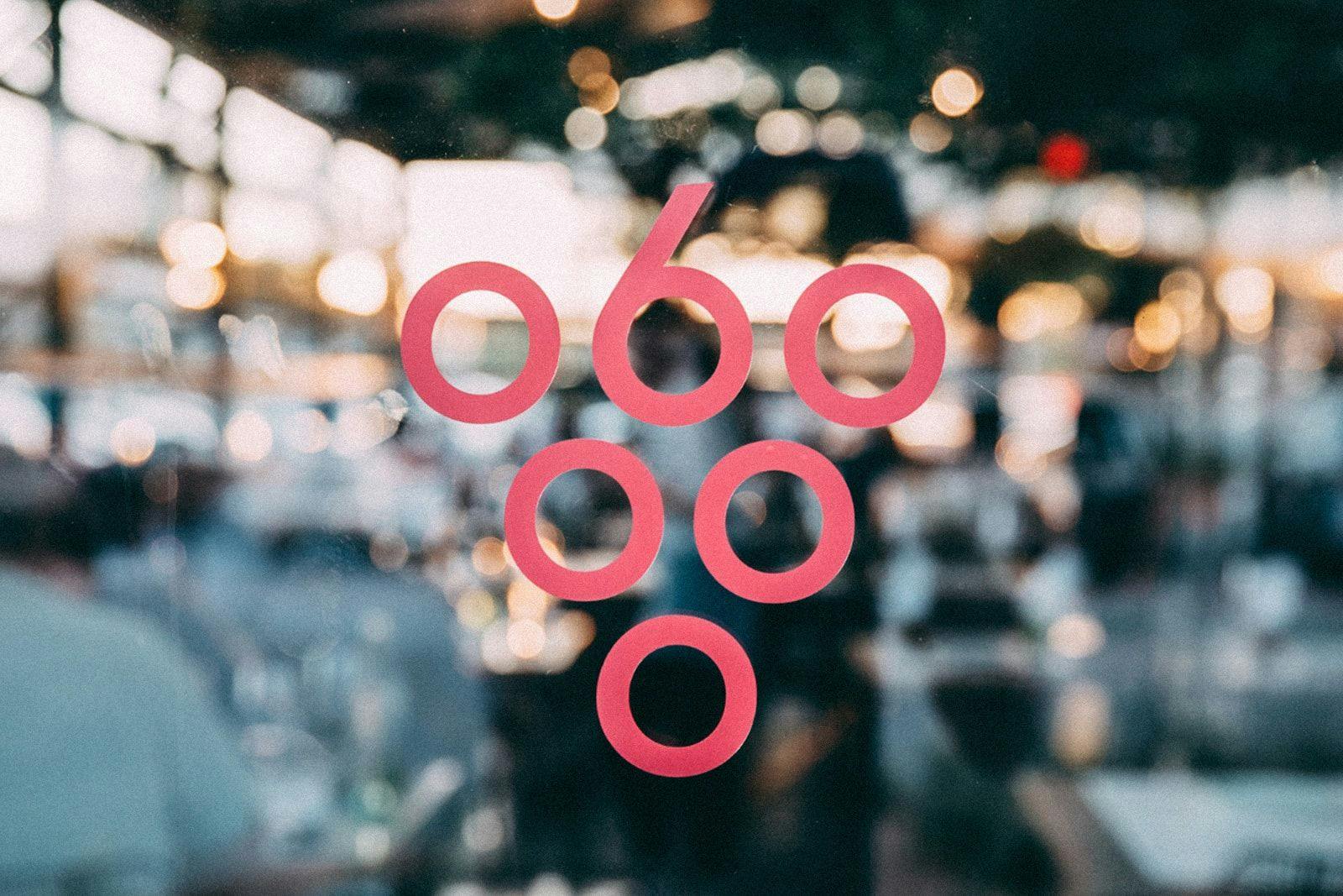Sixty Vines logo in red in front of a blurred background
