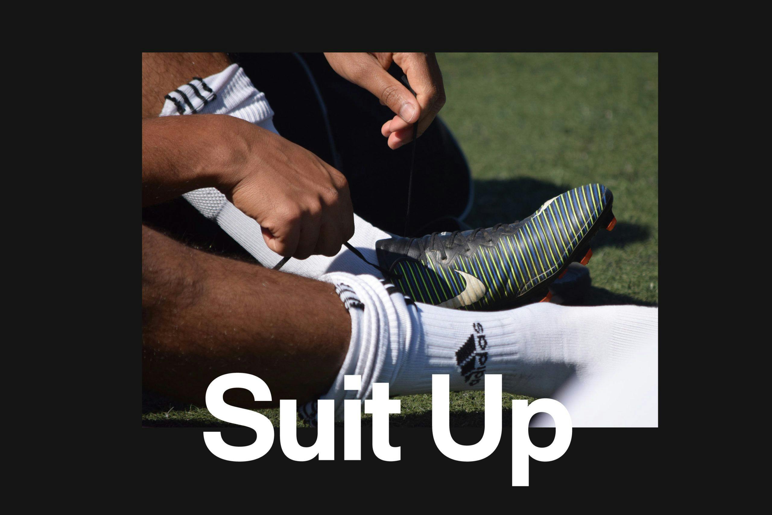 Photo of a track team member lacing their cleats with the words "Suit Up" at the forefront