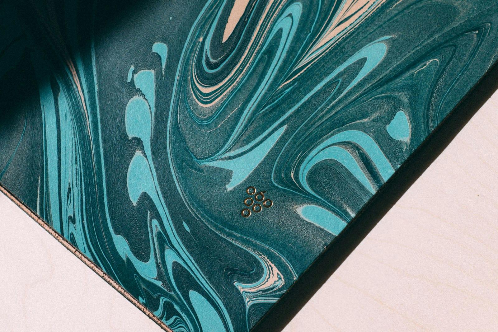 A close up of a blue marble menu with the Sixty Vines logo