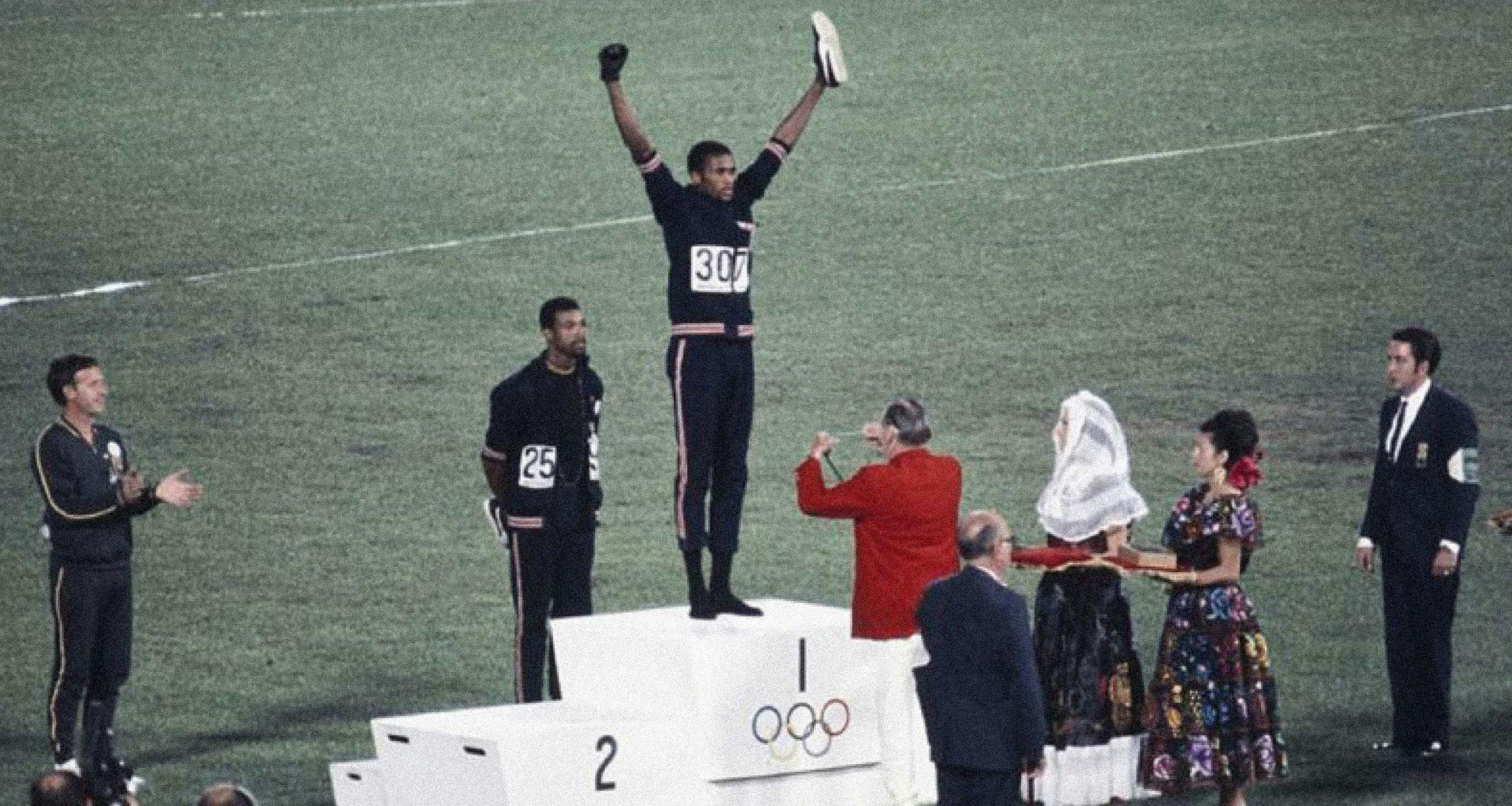 Tommie Smith and John Carlos making a defiant gesture from the awards podium at 1968 Olympics
