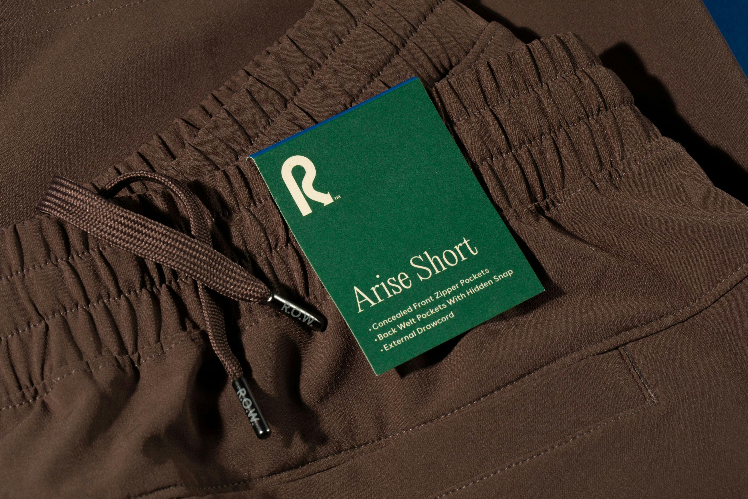 Brown shorts with drawstrings and a green product tag